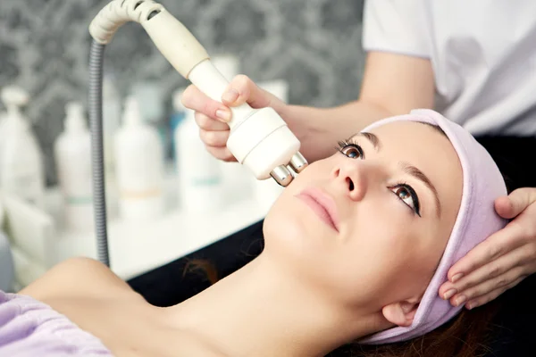 Woman face treatment in medical spa center