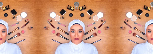 Woman in full makeup surrounded by makeup
