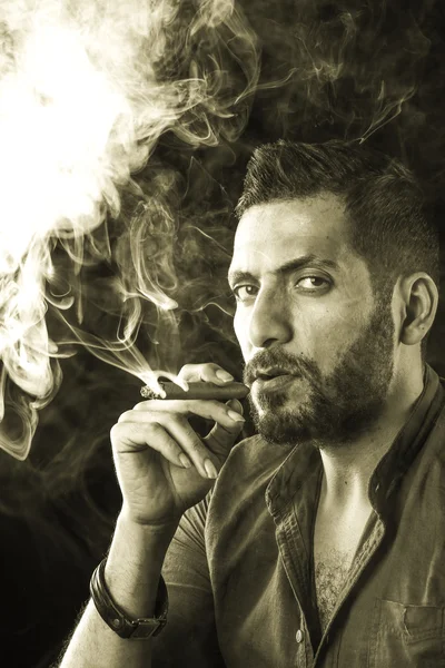 Man Smoking Cigar surrounded by Smoke