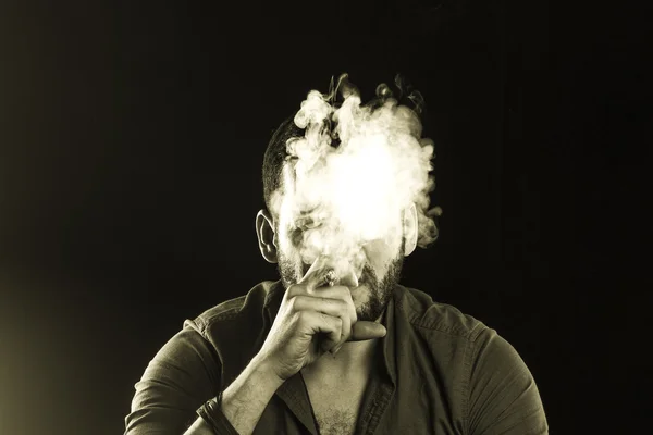 Man Smoking Cigar surrounded by Smoke