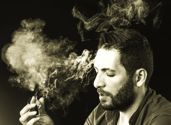 Man Smoking Cigar surrounded by Smoke