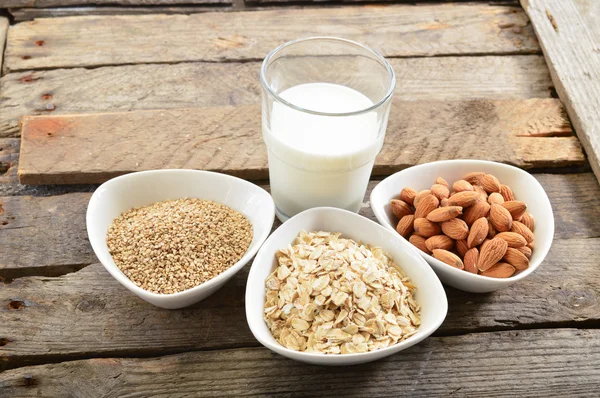 Different vegan milk in glass. Almond milk, sezame milk and oatm