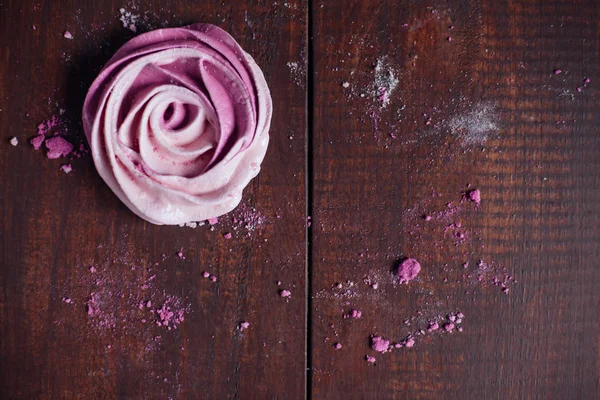 French pink meringue cookies on wooden background. Christmas bak