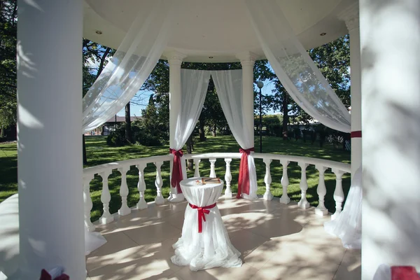 Wedding. Wedding ceremony. Arch.Rotunda. Table, decorated with r