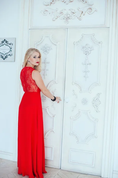 Full-length portrait of young beautiful blonde woman with red lips