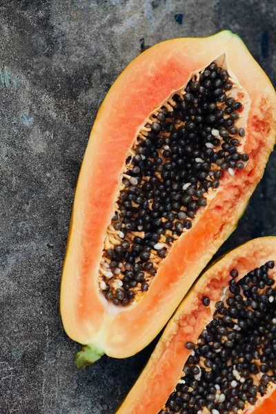 Sliced papaya fruit on black background