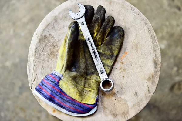 Worker's glove holding a wrench key