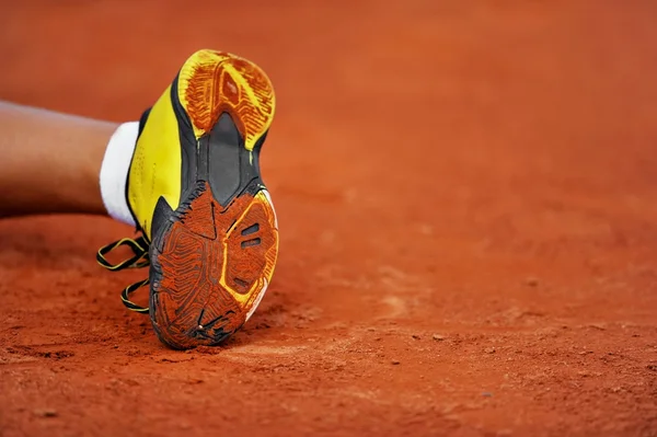 Shoe sole on a tennis clay court