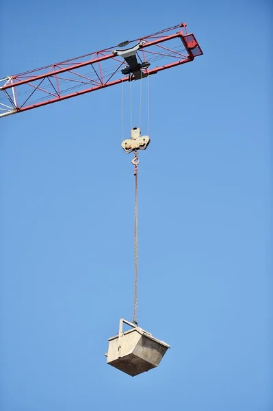 Construction crane loading a container