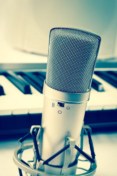 Microphone in recording studio on a white background. Vintage style