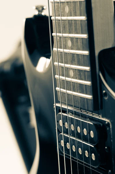 Detail of six-string electric guitar closeup, selective focus.Processed with vintage style