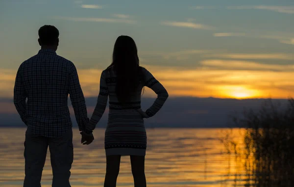 Couple holding hands at the lake