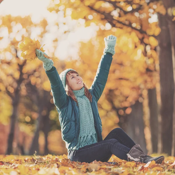 Happy young woman in the autumn park