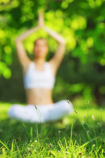 Woman meditating in lotus position.