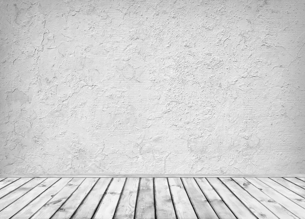 Empty grey dirty concrete wall and wooden floor