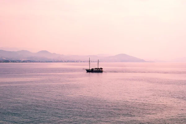 Excursion ship sailing late in the afternoon with setting sun