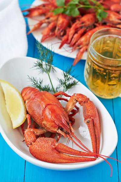 Red boiled crayfish and a glass of beer
