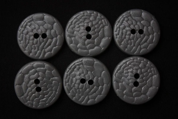Six gray buttons