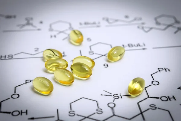 Chemistry science formula and oil capsules. Medicine concept