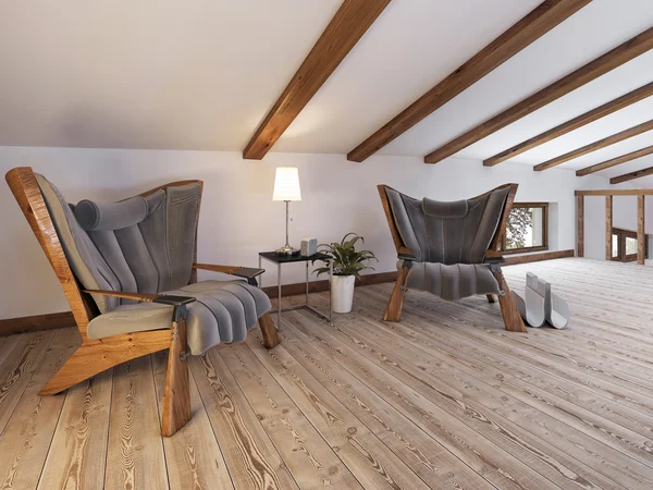 The attic floor with a seating area with designer chairs