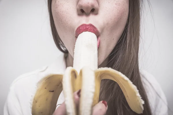 Woman eating a banana