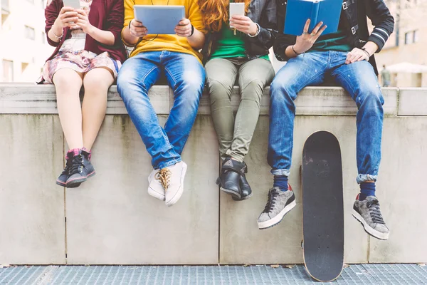 Group of teenagers sitting in an urban area