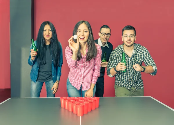 Young people playing beer pong
