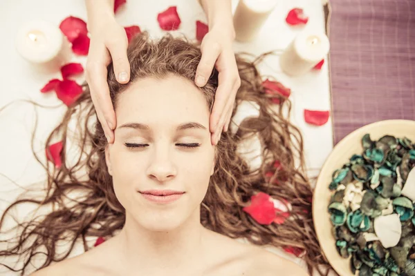 Head massage. young woman making massage in the spa