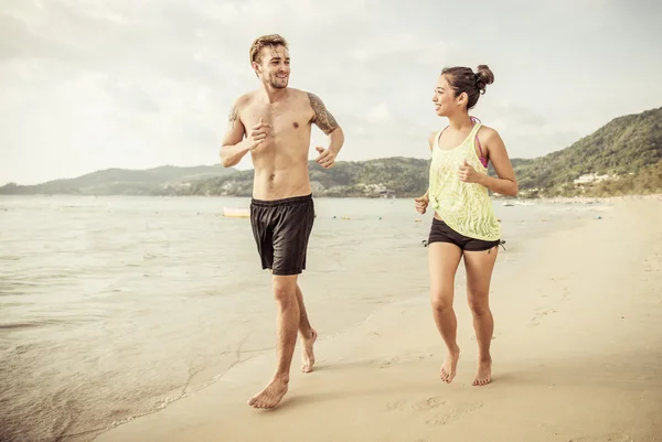 Mixed race couple running on the beach
