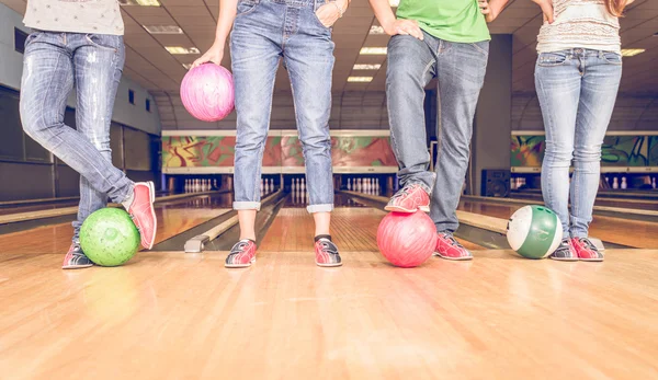 Scene with four people and bowling balls