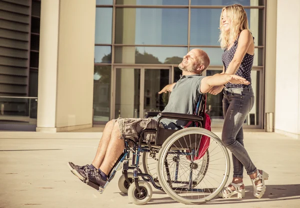 Woman and her boyfriend on the wheelchair