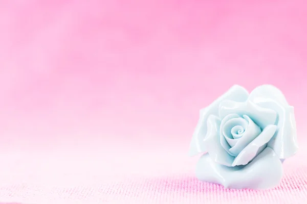 Pastel Rose (Ceramic ) on pink fabic background