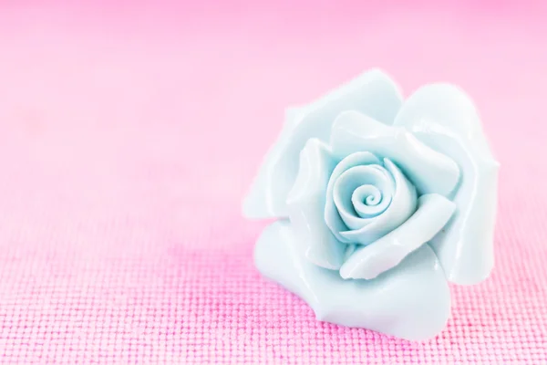 Pastel Rose (Ceramic ) on pink fabic background