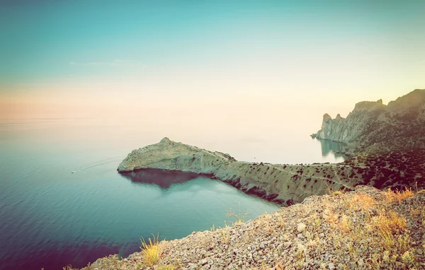 Vintage sea landscape with a sunset and mountain, instagram effe