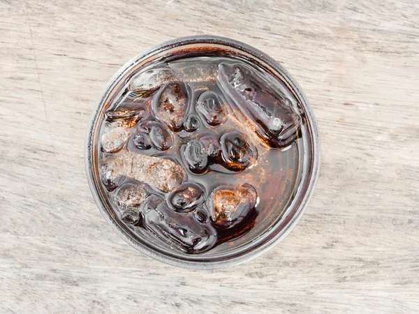 Glass of cola with ice from top view