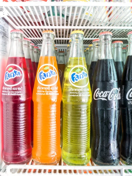 Group of Coca-Cola and Fanta Bottles on shelf in refrigerator
