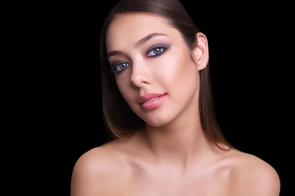 Close portrait of a beautiful girl with a red lips and smoky eyes. Isolated on black background. Copy space.