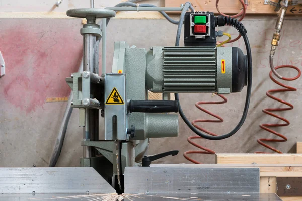 Fixed circular buzz saw with electric motor engine and green red buttons