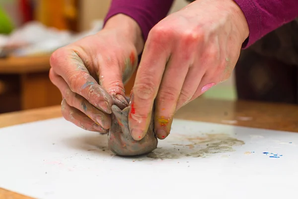 Hands stained with clay and paint. Hands painter and sculptor. C