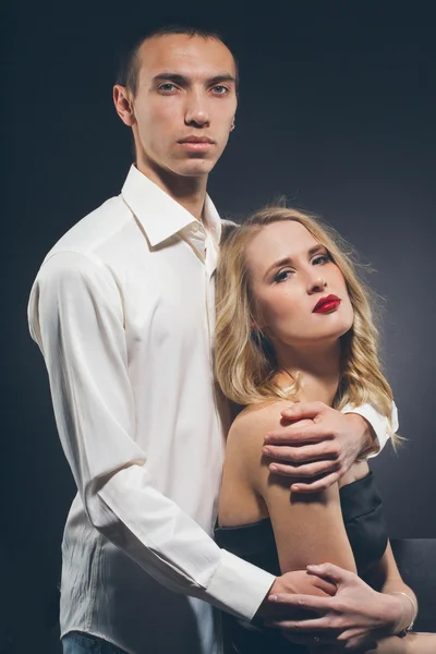 Couple Classic suit black dress woman and man on black background studio with red lipstick and white clothes