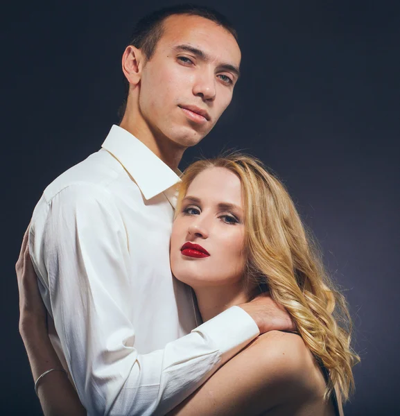 Couple Classic suit black dress woman and man on black background studio with red lipstick and white clothes