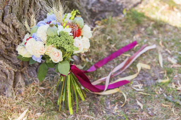 Wedding bouquet of summer flowers laying on green grass. Spring,