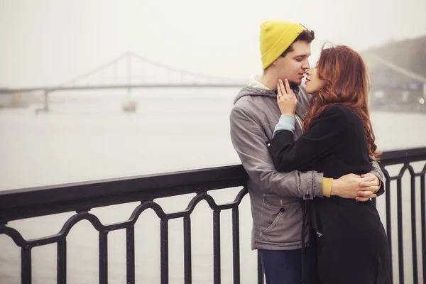 Cute brunette loving couple on a date. cold autumn, winter or sp