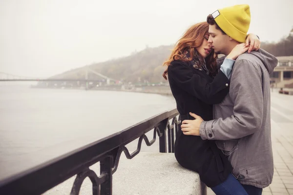 Cute brunette loving couple on a date. cold autumn, winter or sp