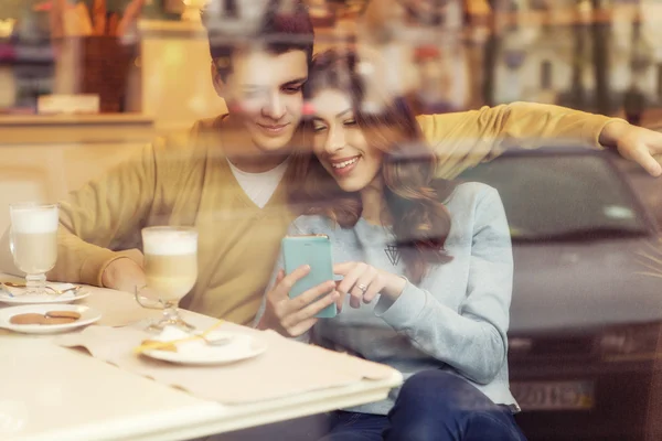 Cute brunette loving couple in cozy warm sweaters on a date at t