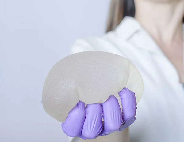 Silicone breast implants. Nurse holding implants. Doctor holding implants. Plastic surgery