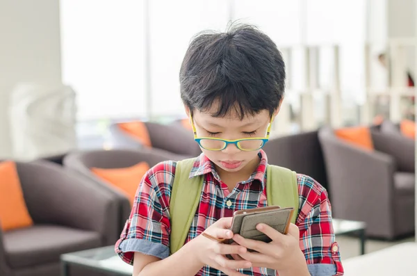 Boy searching map on smart phone