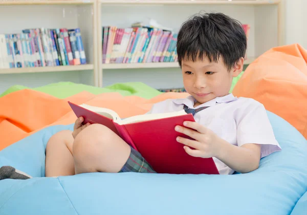 Student reading book in school library