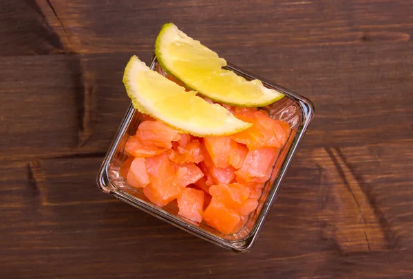 Cubes of smoked salmon on top wood