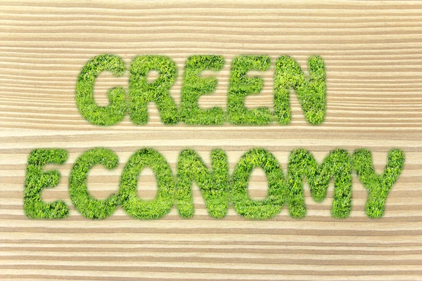 Green economy writing made of grass texture